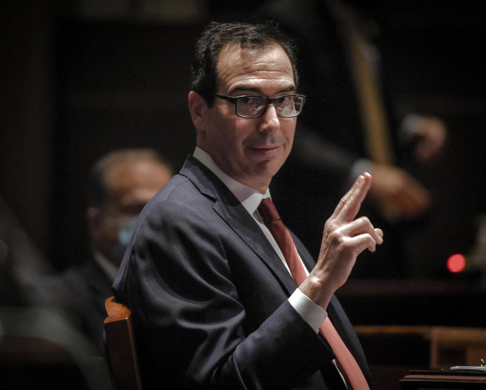Treasury Secretary Stephen Mnuchin, gestures toward Federal Reserve Board Chairman Jerome Powell, as they appear before a House Committee on Financial Services hearing on oversight of the Treasury Department and Federal Reserve pandemic response, Tuesday, June 30, 2020 on Capitol Hill in Washington. (Bill O'Leary/The Washington Post via AP, Pool)