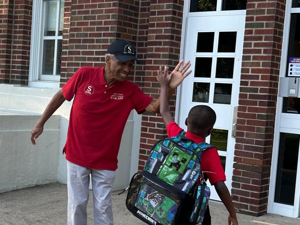 SIMA member Leonard Collins greets a student.