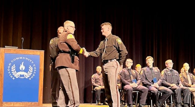 St. Joseph County Undersheriff Jason Bingaman congratulates graduate Hunter Zinsmaster last month at Kellogg Community College in Battle Creek. Zinsmaster, whose first day on the job was Dec. 20, works the day shift for the Centreville-based agency.
