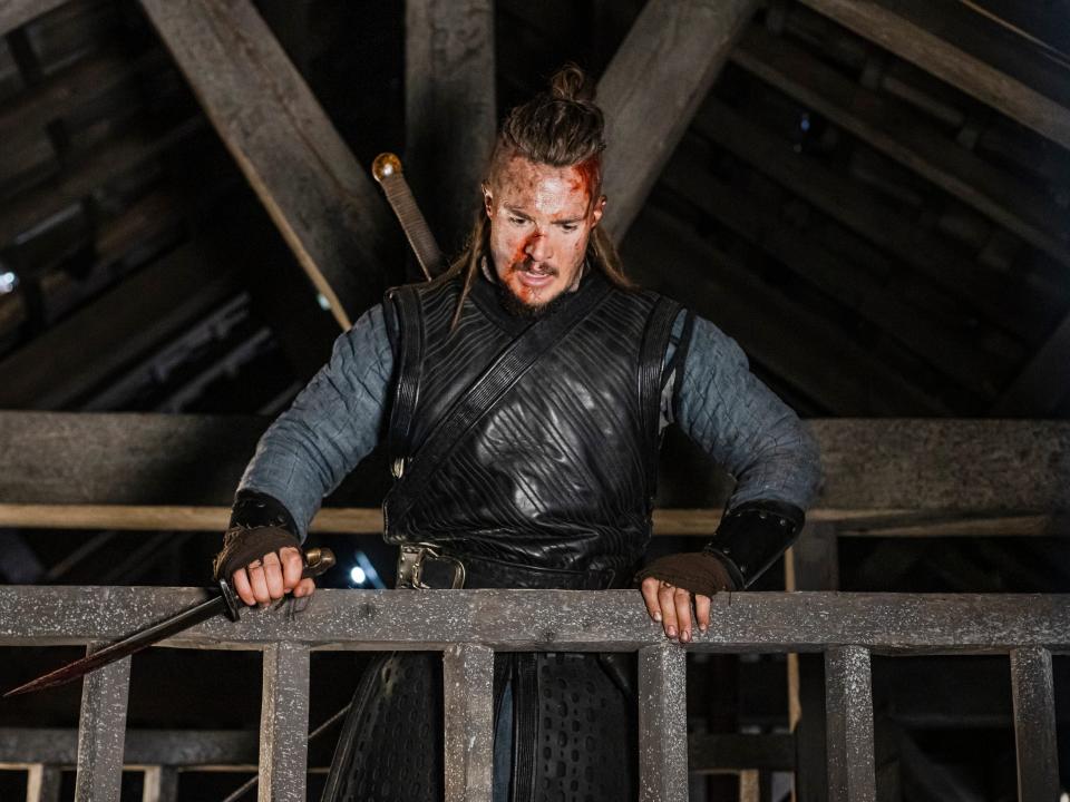 Alexander Dreymon in a Viking outfit with blood on face in "The Last Kingdom"