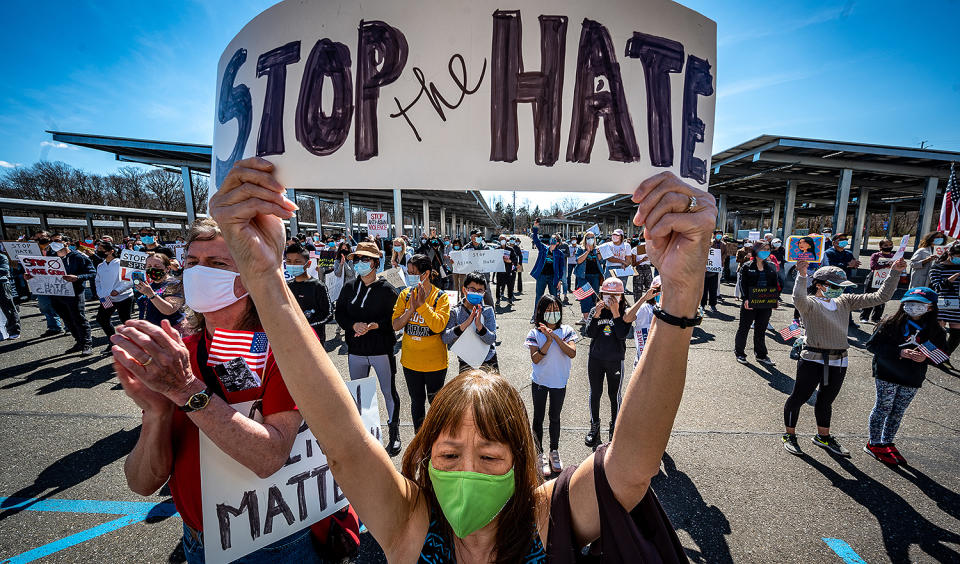 <p>Patricia Shih held up a "Stop the Hate" sign in Hauppauge, New York as many rallied at the H. Lee Dennison Building on March 27.</p>