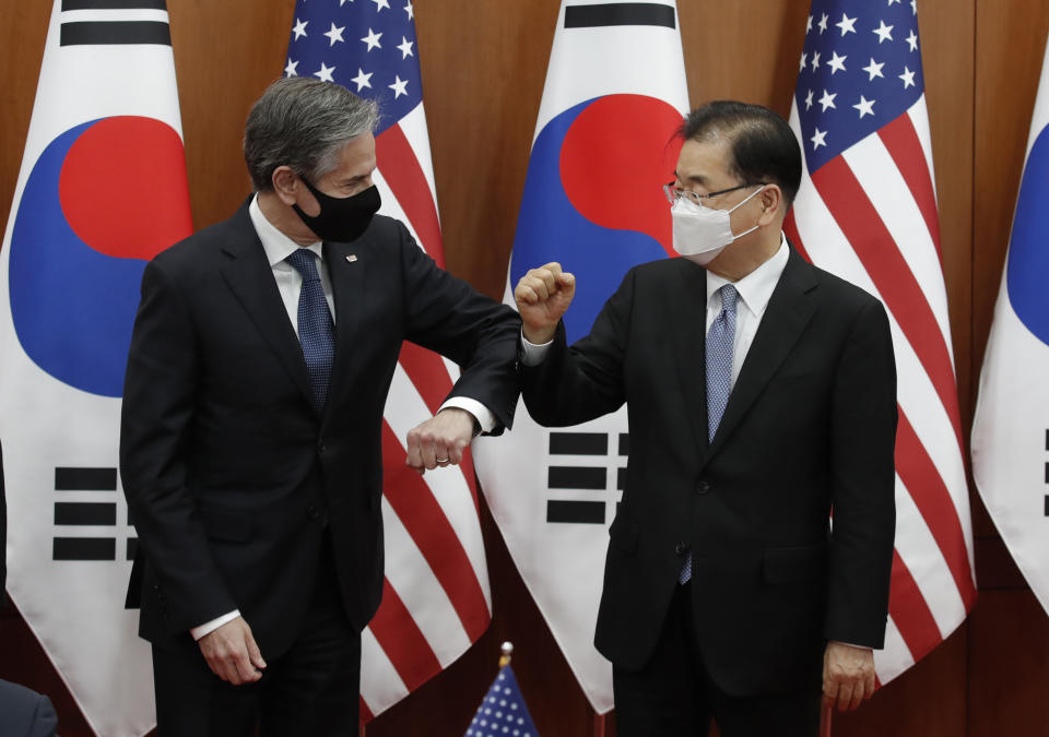 U.S. Secretary of State Antony Blinken, left, bump elbows with South Korean Foreign Minister Chung Eui-yong after an initialing ceremony for Special Measures Agreement at the Foreign Ministry in Seoul, South Korea, Thursday, March 18, 2021. (AP Photo/Lee Jin-man, Pool)