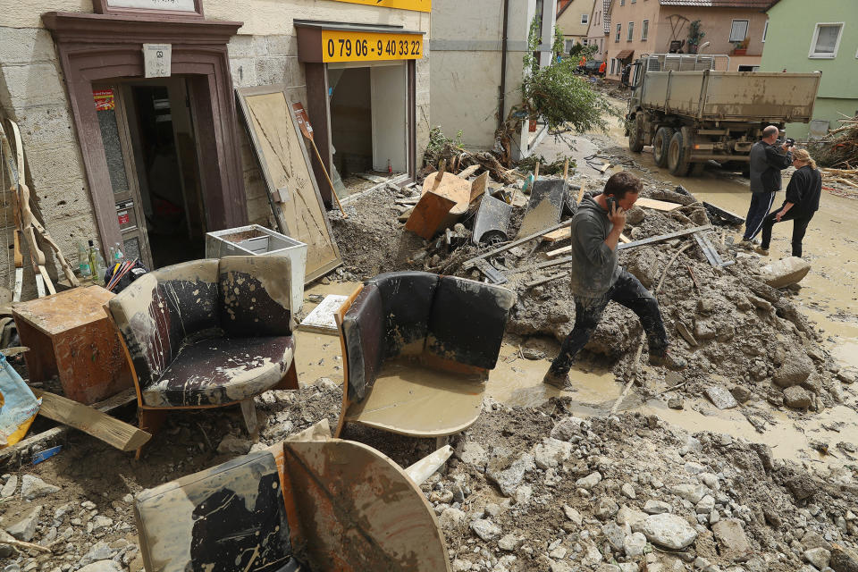 <p>People begin cleanup efforts by hauling ruined household items from a business on May 30, 2016, following a furious flash flood in Braunsbach, Germany. (Sean Gallup/Getty Images) </p>