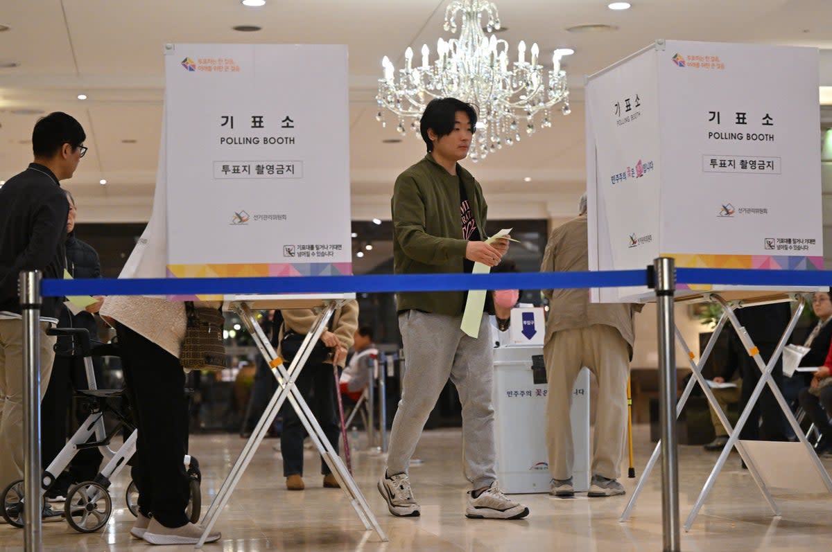 South Koreans cast their ballots during the parliamentary elections at a polling station located in a wedding hall in Seoul on 10 April 2024 (AFP via Getty Images)
