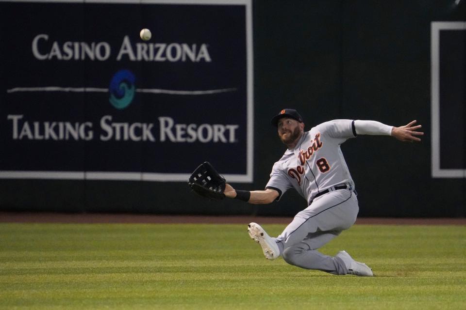 Detroit Tigers left fielder Robbie Grossman (8) makes a sliding catch against the Arizona Diamondbacks during the first inning at Chase Field in Phoenix on June 24, 2022, in Phoenix.
