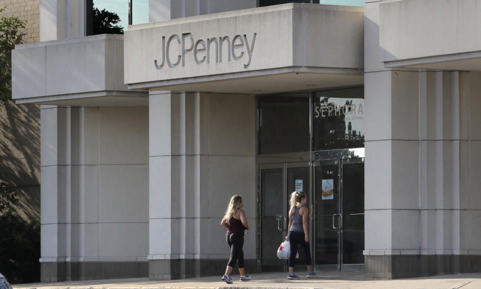 FILE - In this Aug. 14, 2019, file photo two women walk into the JCPenney store in Peabody, Mass. J.C. Penney Co. reports earnings Thursday, Feb. 27. (AP Photo/Charles Krupa, File)