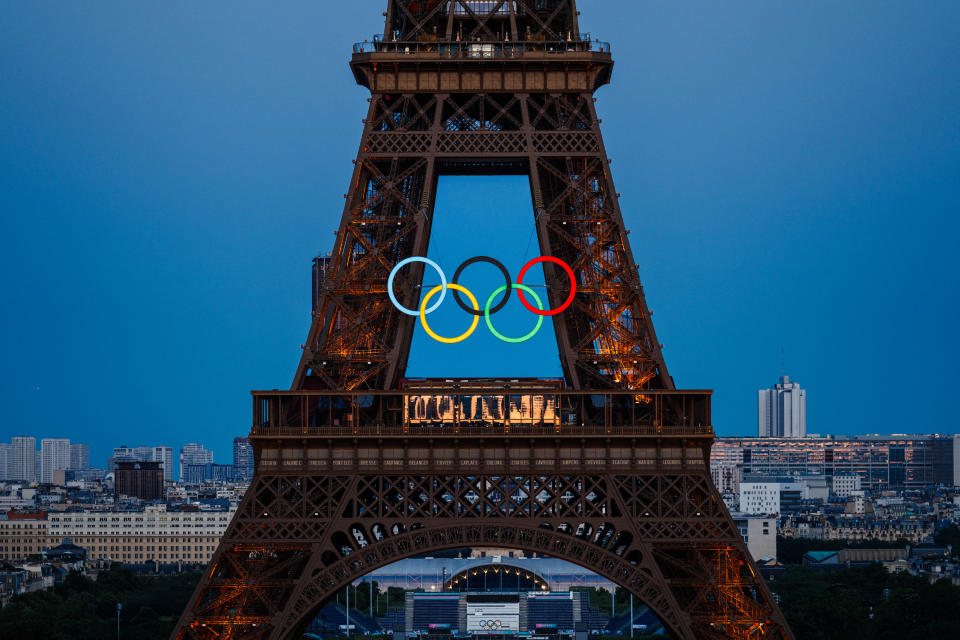 the Olympic Rings on the Eiffel Tower ahead of the traditional fireworks marking the annual Bastille Day in Paris, on July 14, 2024. The torch relay ahead of the Paris Olympics reached the French capital for the first time, with organisers hoping to build enthusiasm for the Games (Photo by Dimitar DILKOFF / AFP) (Photo by DIMITAR DILKOFF/AFP via Getty Images)