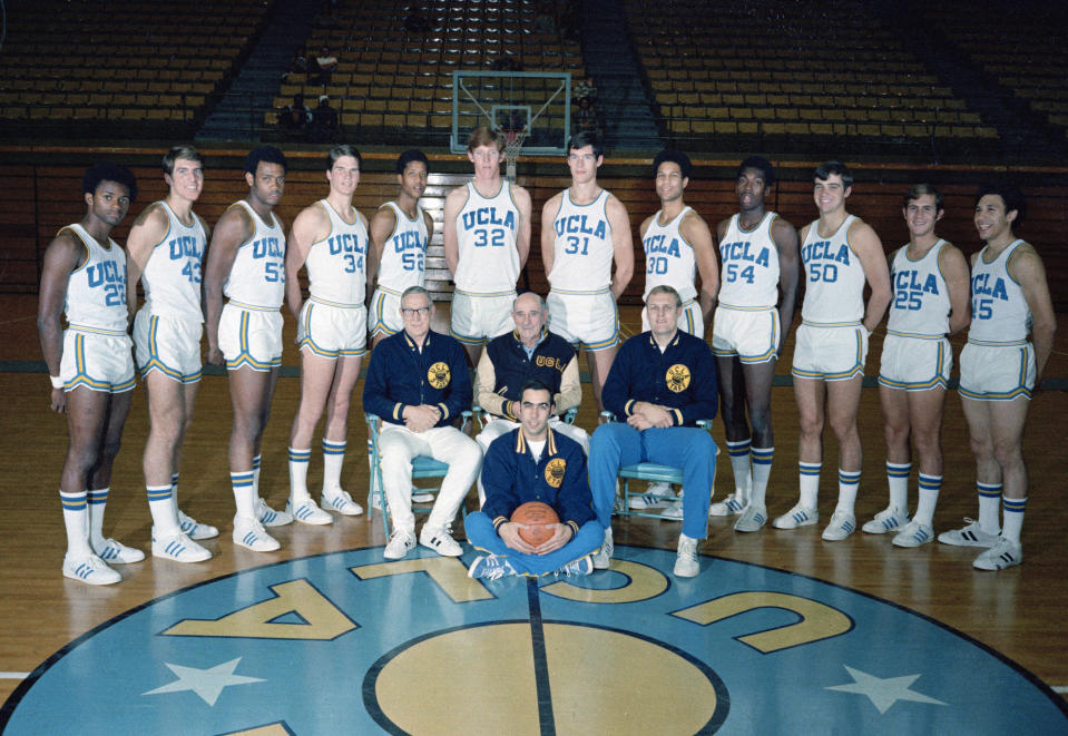 FILE - The UCLA NCAA college basketball team is seen in 1972. Standing, from left to right: Tommy Curtis, Greg Lee, Larry Hollyfield, Jon Chapman, Keith Wilkes, Bill Walton, Swen Nater, Vince Carson, Larry Farmer, Gary Franklin, Andy Hill, and Henry Bibby. Head coach John Wooden sits at left. Other coaches are unidentified. (AP Photo/File)