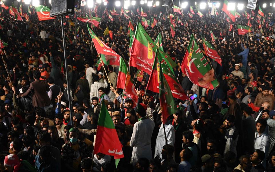 Supporters of Pakistan's former prime minister Imran Khan gather at a rally in Lahore - ARIF ALI/AFP via Getty Images