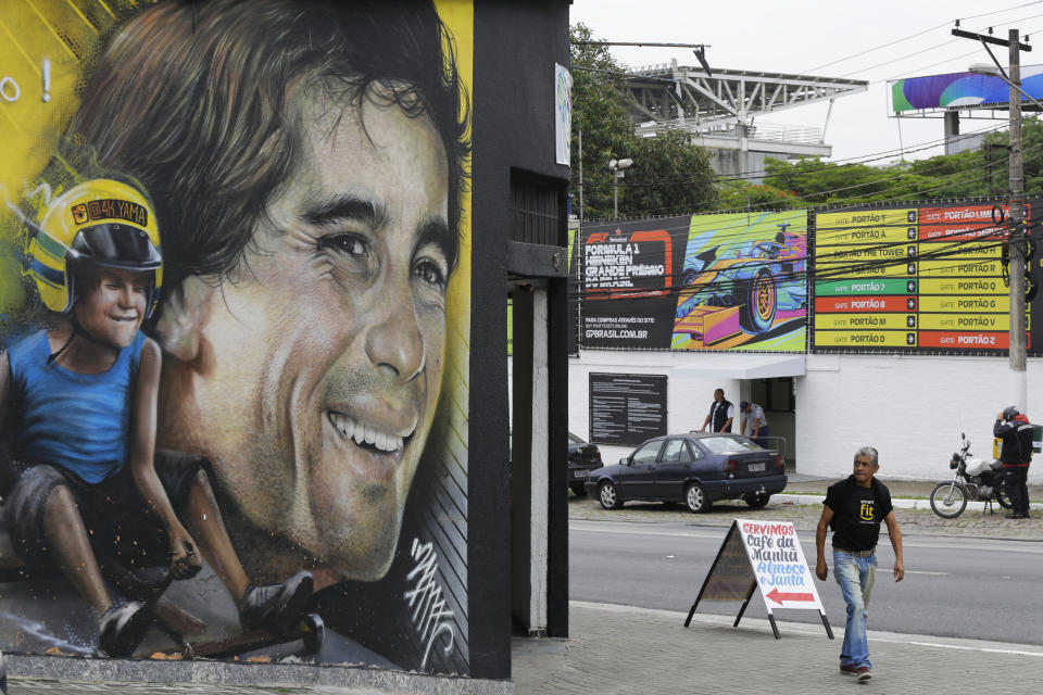 In this Nov. 7, 2019 photo, a mural depicts legendary Brazilian F1 driver Ayrton Senna on a business front near the Interlagos racetrack in Sao Paulo, Brazil. Many bars on busy streets like Avenida Paulista are open 24 hours a day during the Brazil F1 GP race, and hotels prepare feasts at early hours so fans don't need to refuel at the track. (AP Photo/Nelson Antoine)