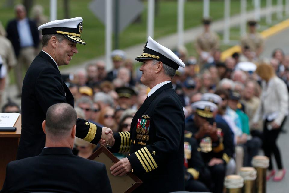Naval Weapons Station Earle's former Commander Captain Edward L. Callahan shakes hands with Rear Admiral Brian L. Davies during the Change of Command ceremony in Colts Neck Friday, April 21, 2023.