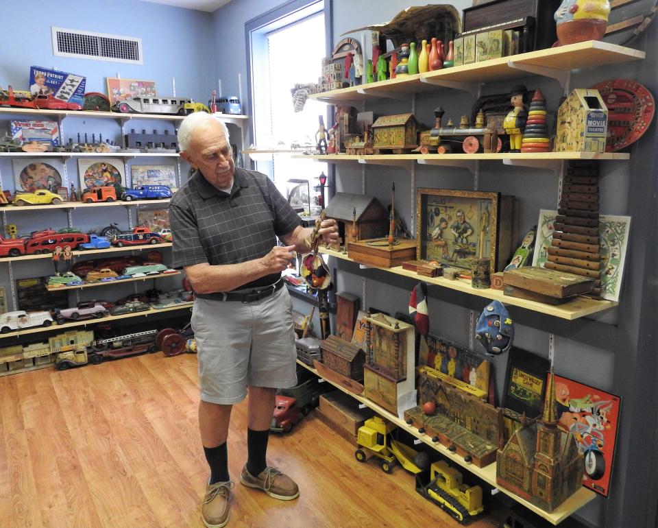 Richard Hoover shows a piece from his collection of classic toys on display in The Toy Cellar in the basement of the Hay Craft Center in Roscoe Village.