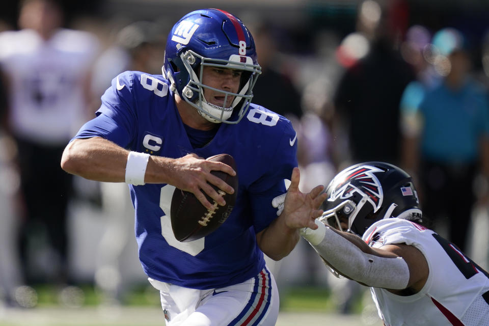 New York Giants quarterback Daniel Jones (8) looks to pass under pressure from Atlanta Falcons defensive tackle Ta'Quon Graham, right, during the second half of an NFL football game, Sunday, Sept. 26, 2021, in East Rutherford, N.J. (AP Photo/Seth Wenig)