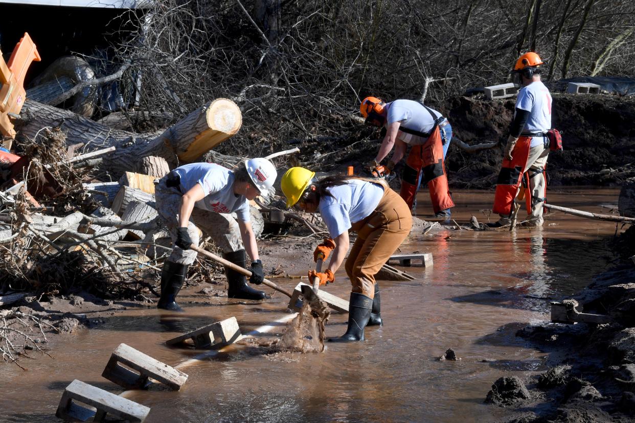 Team Rubicon volunteers Lisa Bodenburg, Kathy Torres, Howard Szabo and Gary Taylor clear a creek on Wednesday, Jan. 25, 2023 that had filled with trees and sediment on an Oak View property. Recent storms caused the Ventura River to rise well above normal flooding a garage, pool and other structures.