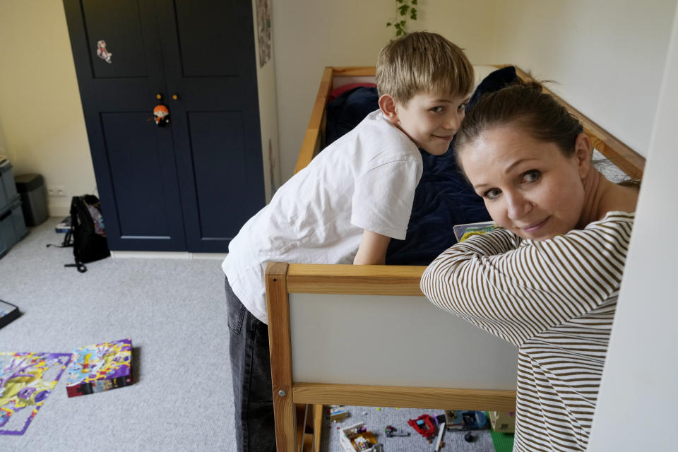 Magda Kozak, right, spends time with her son Julian, 9, at their home in Warsaw, Poland, Friday, April 5, 2024. Neither of them is happy that starting in April, Poland's government has ordered strict limits on the amount of homework that teachers can impose on the lower grades. (AP Photo/Czarek Sokolowski)