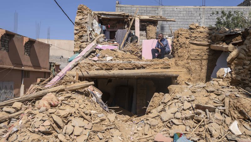 A man who lost his wife and daughter in the earthquake sits in what used to be his home, in the town of Amizmiz, outside Marrakech, Morocco, on Thursday, Sept. 14, 2023. 