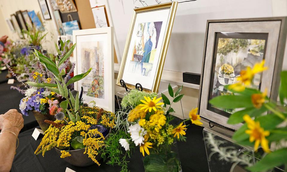 "Art in Bloom" brings local florists and artists together. Members of the Seaside Gardeners, a local club, recreate works of art by students at the Marshfield Senior Center through flower arrangements.