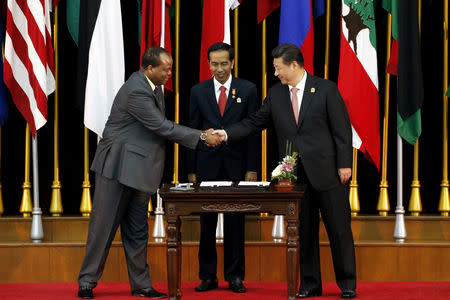 FILE PHOTO: China's President Xi Jinping (R) shakes hands Swaziland's King Mswati III (L) as Indonesia's President Joko Widodo (C) looks on after the signing ceremony of the Bandung Message marking the 60th Asian-African Conference Commemoration at Gedung Merdeka in Bandung, West Java, April 24, 2015. REUTERS/Bagus Indahono/Pool/File Photo