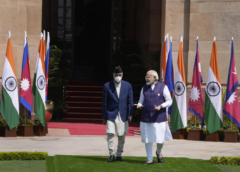 Indian Prime Minister Narendra Modi, right, speaks with his Nepalese counterpart Sher Bahadur Deuba before their meeting in New Delhi, India, Saturday, April 2, 2022. Deuba is on a three-day official visit to India. (AP Photo/Manish Swarup)