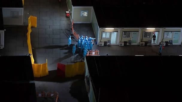 PHOTO: Health workers at a COVID-19 isolation facility, March 7, 2022, in Hong Kong, China. (Louise Delmotte/Getty Images, FILE)