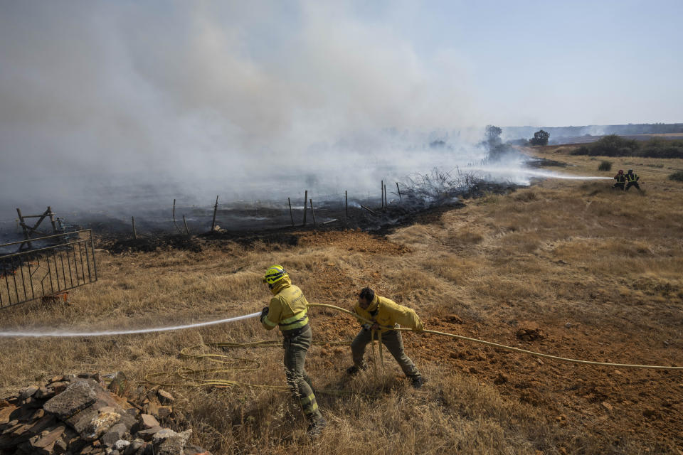 FILE - Firefighters work at the scene of a wildfire in Tabara, north-west Spain, Tuesday, July 19, 2022. Major wildfires in Europe are starting earlier in the year, becoming more frequent, doing more damage and getting harder to stop. And, scientists say, they’re probably going to get worse as climate change intensifies unless countermeasures are taken. (AP Photo/Bernat Armangue, File)