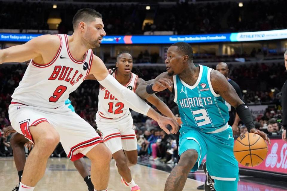 Chicago Bulls center Nikola Vucevic (9) defends Charlotte Hornets guard Terry Rozier (3) during the first quarter at United Center.