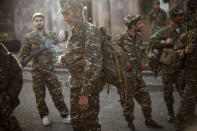 FILE - In this Sept. 29, 2020 file photo, ethnic Armenian volunteer recruits gather at a center to receive their uniforms and weapons before being dispatched to the frontline near Hadrut, self-proclaimed Republic of Nagorno-Karabakh, Azerbaijan. Hundreds of fighters from around the Middle East are heading to Nagorno-Karabakh in Azerbaijan to join rival countries fighting over the region. (AP Photo/Karen Mirzoyan, File)