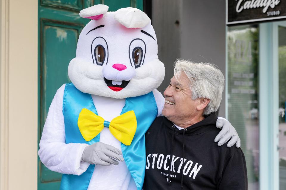 Eddie Masingale, of Stockton, smiles as he gets a photo with the Easter Bunny at the Yosemite Street Village's 2nd Annual Easter Egg Hunt on Saturday, April 16, 2022, in Stockton.