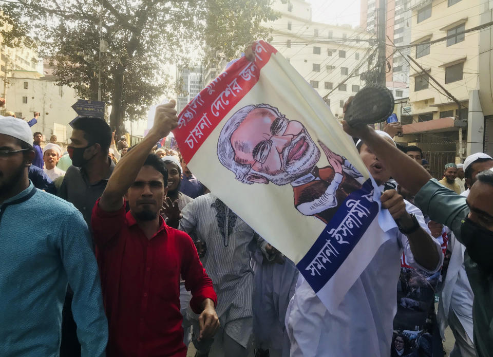 Bangladeshis protest against the communal violence in New Delhi, after Friday prayers in Dhaka, Bangladesh, Friday, Feb. 28, 2020. Authorities have not said what sparked the riots, the worst communal violence in New Delhi in decades, as the the toll continued to rise. The protestors also raised slogans against the visit of Indian Prime Minister Narendra Modi who is scheduled to visit Bangladesh in mid-March. Poster reads "Bangladeshis do not want terrorist Modi to come here." (AP Photo/Al-emrun Garjon)