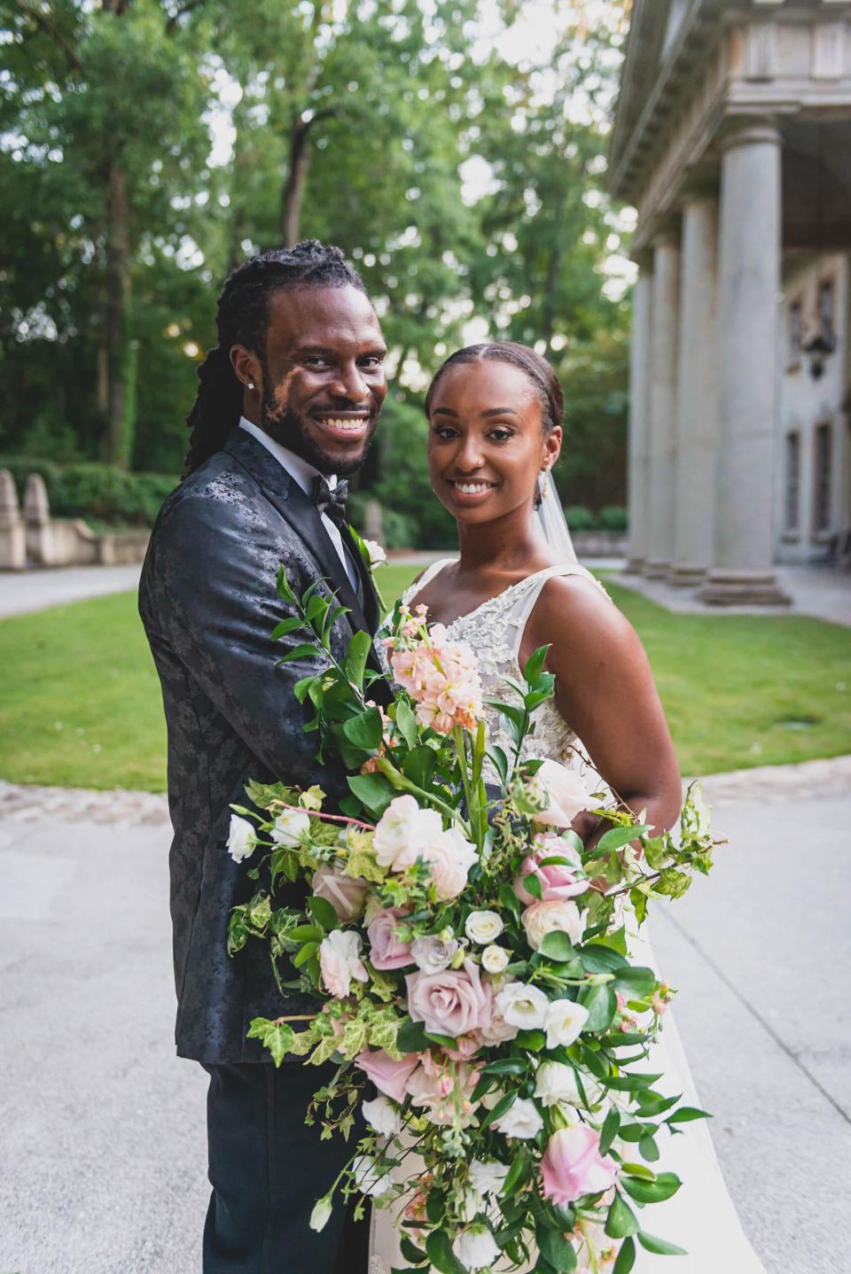 A bride and groom smile on their wedding day.