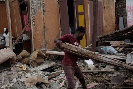 A man clears debris after Hurricane Matthew in Port-a-Piment, Haiti, October 9, 2016. REUTERS/Andres Martinez Casares