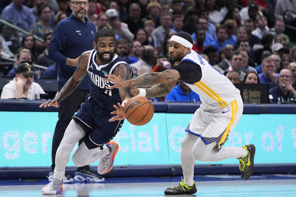 Dallas Mavericks guard Kyrie Irving (11) and Golden State Warriors guard Gary Payton II reach for the ball during the second half of an NBA basketball game in Dallas, Friday, April 5, 2024. (AP Photo/LM Otero)