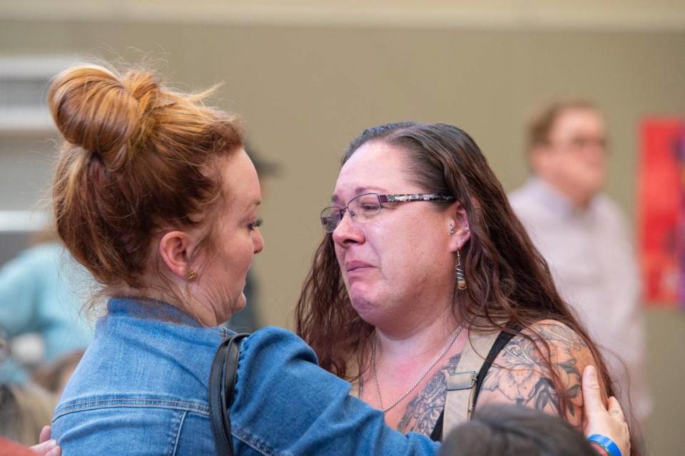 Alison Warren, left, the aunt of a preschooler seriously injured by a van while crossing the street with her classmates, consoles teacher Carrie Molaug at a community meeting in June at Pinewood Elementary in Pollock Pines. Molaug was of one of two teachers supervising the students when the collision occurred.