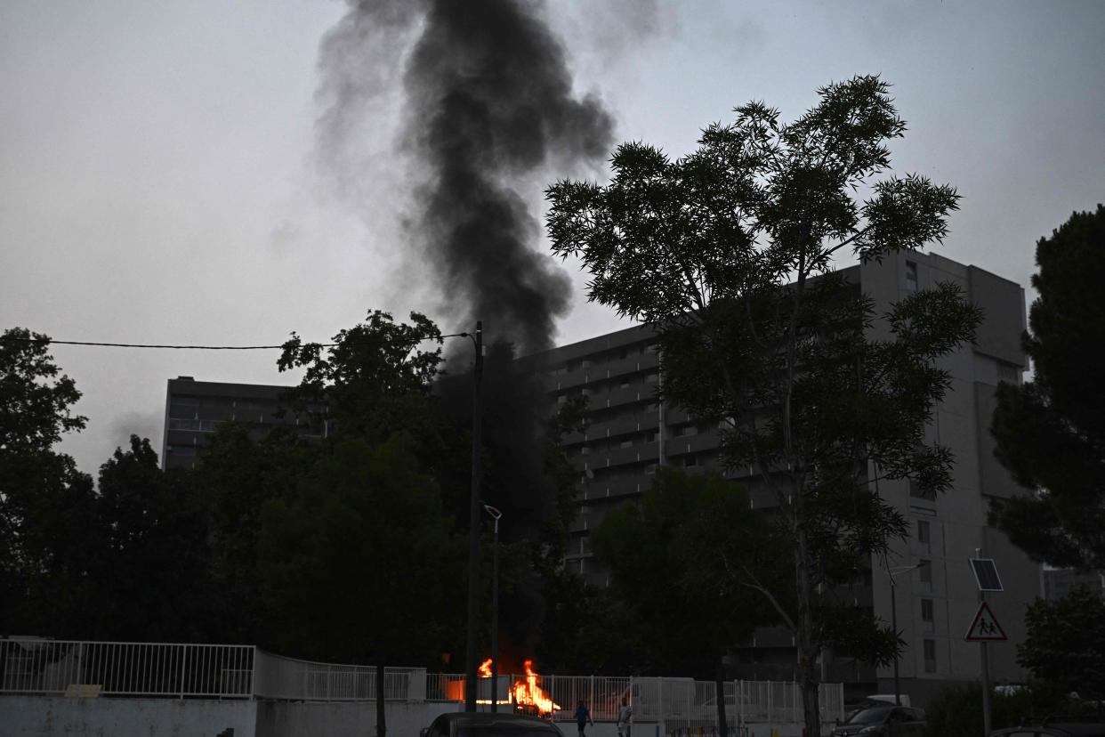 Smoke rises from a bonfire in a residential area during clashes in Toulouse, southwestern France on 28 June 2023 (AFP via Getty Images)