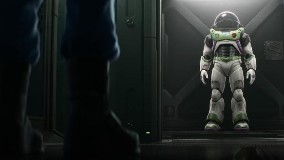 The real Buzz looks at his space ranger suit in Lightyear from Disney and Pixar