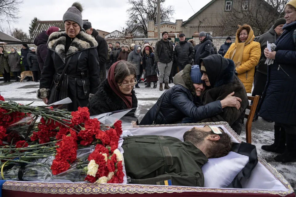 Mourners in Kharkiv, Ukraine grieve on Monday, Feb. 6, 2023, during the funeral of Anton Pushkar, a Ukrainian soldier who was killed in fighting near Bakhmut, in eastern Ukraine.  (Lynsey Addario/The New York Times)