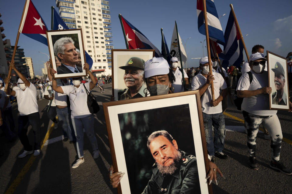 People attend a cultural-political event on seaside Malecon Avenue with thousands of people in a show of support for the Cuban revolution six days after the uprising of anti-government protesters across the island, in Havana, Cuba, Saturday, July 17, 2021 (AP Photo/Eliana Aponte)