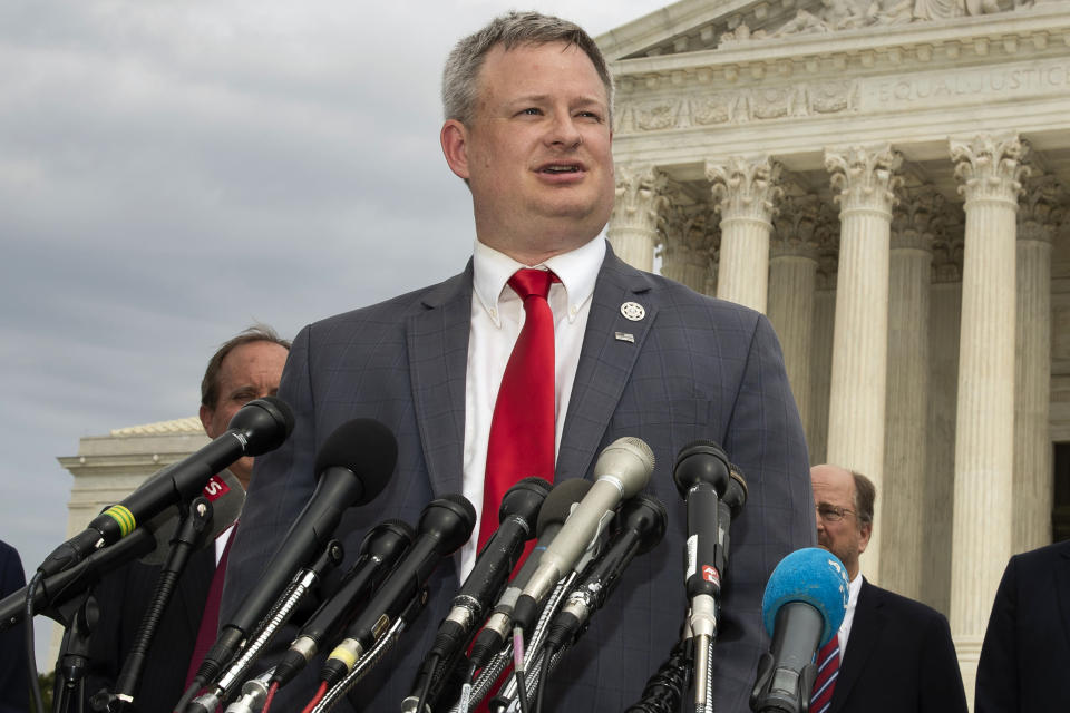 FILE - South Dakota Attorney General Jason Ravnsborg, joined by a bipartisan group of state attorneys general, speaks to reporters in front of the U.S. Supreme Court in Washington, Sept. 9, 2019. South Dakota Gov. Kristi Noem’s cabinet secretary who oversaw an investigation into the state’s attorney general for a 2020 fatal car crash have urged House lawmakers to bring impeachment charges against him. Secretary of Public Safety Craig Price alleges in a letter released Wednesday, March 9, 2022, that Ravnsborg was distracted, was untruthful during the investigation and previously traded “disparaging and offensive” text messages with his staff about other state officials. (AP Photo/Manuel Balce Ceneta, File)