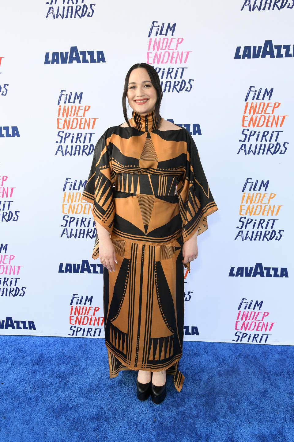 Lily in a patterned dress with mid-length sleeves and ruffled collar at the Film Independent Spirit Awards