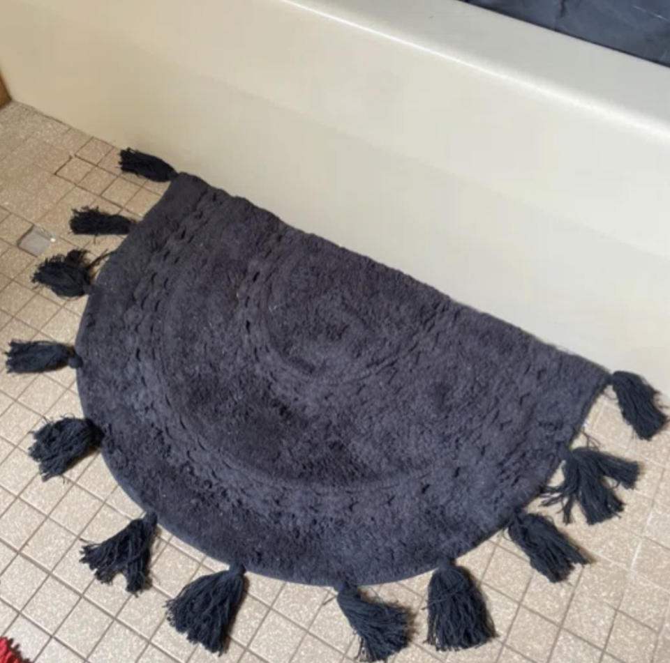 A reviewer's blue bath rug