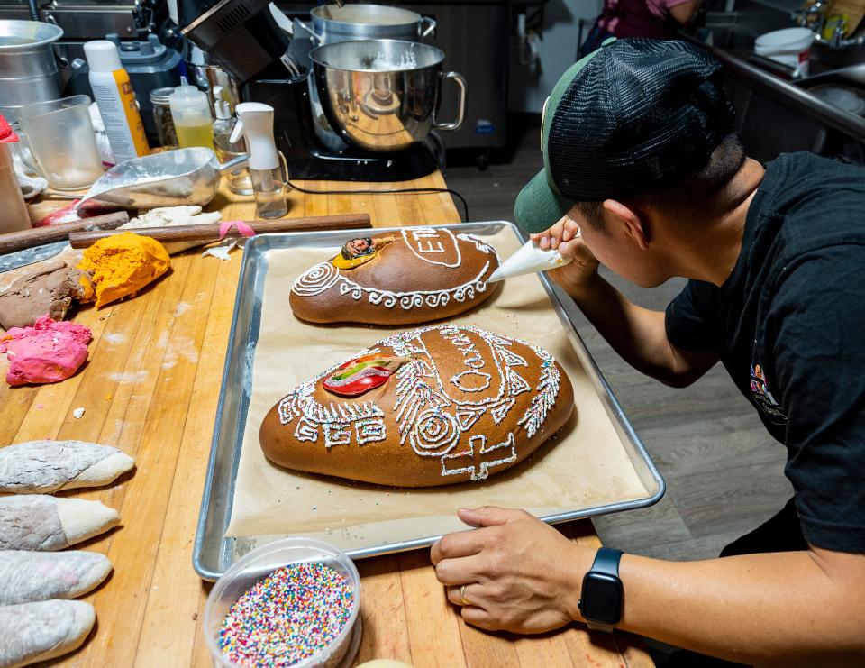 Heladio Garcia, co-owner of La Casa Del Pan Bakery, decorates Pan de Muerto (Bread of the Dead), a traditional Mexican sweet bread that is commonly made during Day of the Dead (Día de los Muertos), on Monday October 23, 2023 in Milwaukee, Wis.