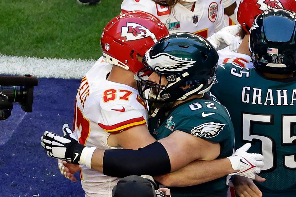 Kansas City Chiefs tight end Travis Kelce (87) embraces his brother Philadelphia Eagles center Jason Kelce (62) before the NFL Super Bowl 57 football game Sunday, Feb. 12, 2023, in Glendale, Ariz.