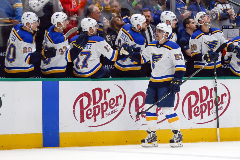 St. Louis Blues left wing David Perron (57) is congratulated by teammates on the bench after scoring a goal against the Dallas Stars during the first period of an NHL hockey game in Dallas, Friday, Feb. 21, 2020. (AP Photo/Ray Carlin)