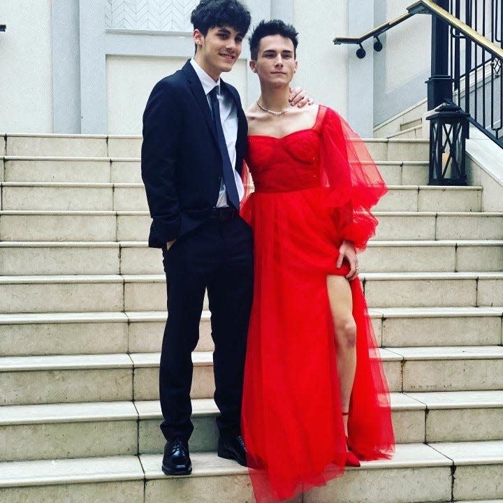 Jacob Geittmann and Dalton Stevens pose before Stevens's high school prom. Stevens wore a dress to break the stigma of men wearing dresses. He was harassed by a man because of his outfit. A video of the incident went viral.