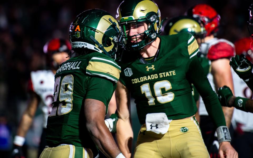 CSU football running back Justin Marshall (29) is congratulated by quarterback Brayden Fowler-Nicolosi (16) after a touchdown against San Diego State at Canvas Stadium in Fort Collins in 2023. Marshall became the first CSU freshman running back to record 100-plus yards on the ground since 1974.