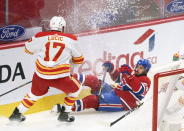 Montreal Canadiens' Phillip Danault falls after taking a hit from Calgary Flames' Milan Lucic during the first period of an NHL hockey game Friday, April 16, 2021, in Montreal. (Paul Chiasson/The Canadian Press via AP)