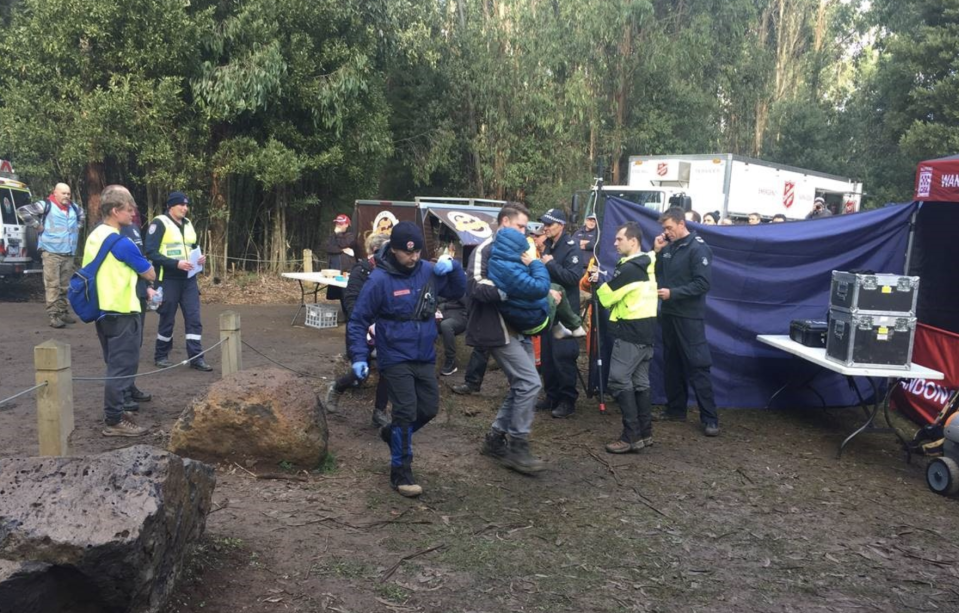 Will is shown being carried through the camp ground set up to search for him. Source: Twitter/VictoriaPolice