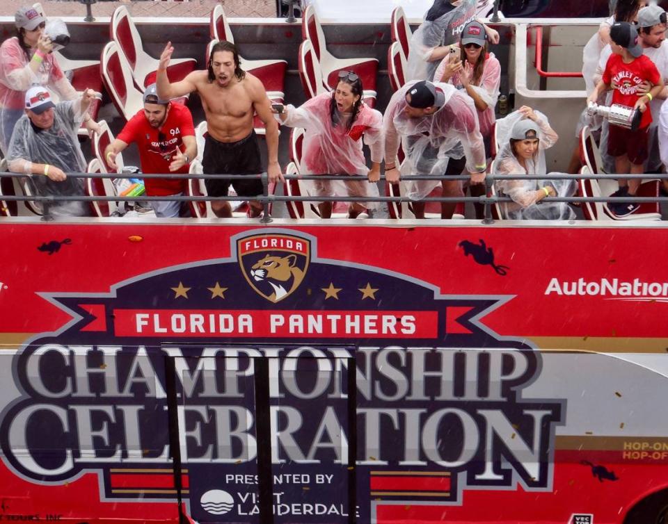 The rain didn’t stop the Panther’s championship celebration as Ryan Lomberg, center, hypes the rain-soaked fans as the double-decker makes its way south on A1A after winning the Stanley Cup during the parade in Fort Lauderdale on Sunday, June 30, 2024.