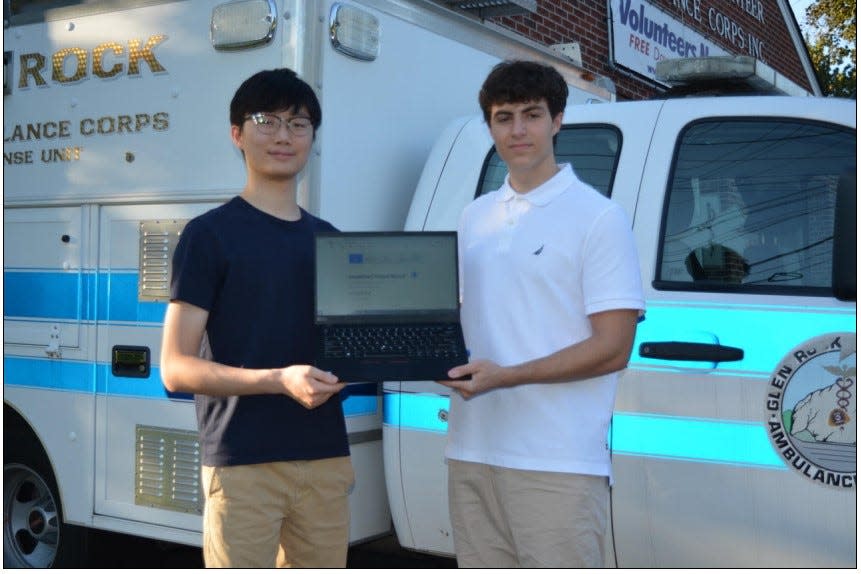 William Song of Fort Lee and Giacomo Pugliese of Glen Rock showing SmartChart program on computer devised to assist ambulance EMTs collect patient data.