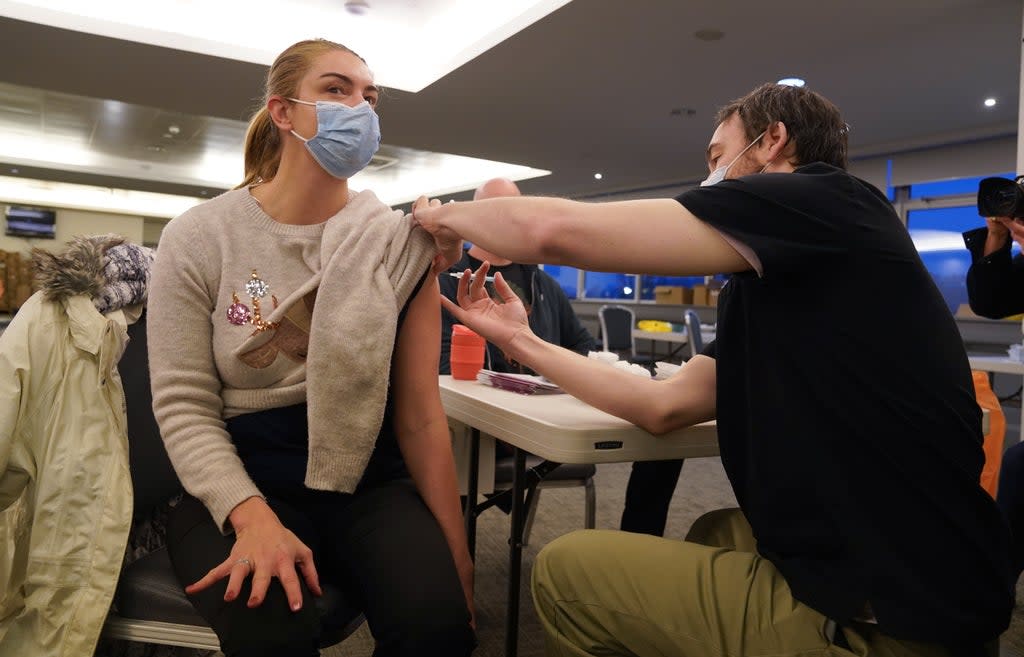 An individual being vaccinated at a Covid-19 booster centre at Hampden Park in Glasgow (PA Wire)